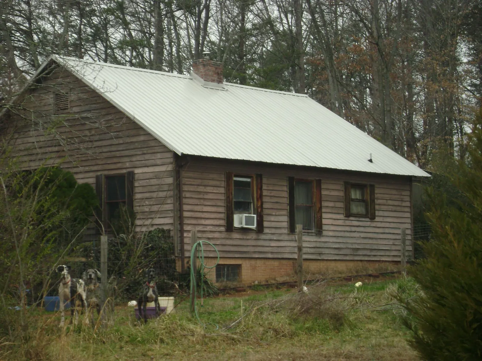 White metal roof on an old wood sided farmhouse, from a Metal Roof Installation job in La Motte